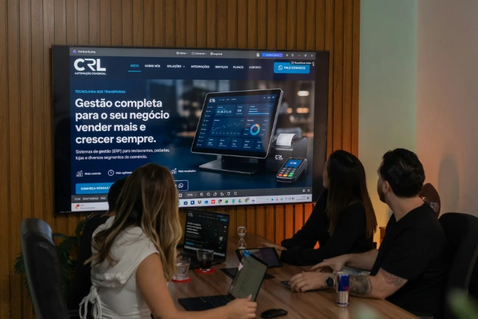 Three colleagues viewing a business presentation on a large screen